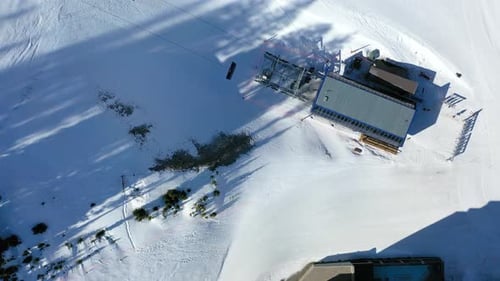 Chair Lift Gliding Over Snowy Slopes and Pines in Winter Mountains