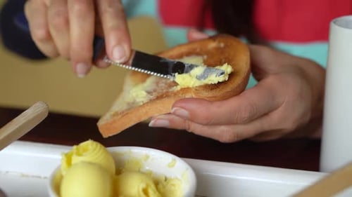 Buttering Toast with Knife for Breakfast