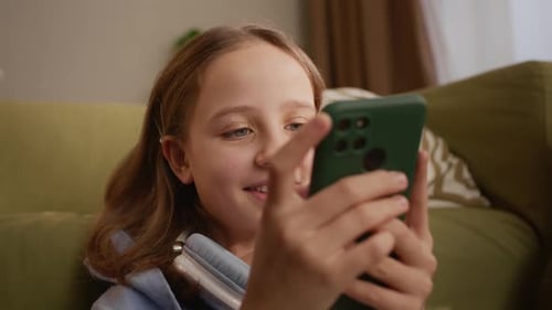 Girl Using Phone Device Indoors on the Couch
