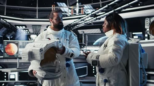 Astronaut Puts Helmet on Before Leaving Space Station Fist Bumping Colleague
