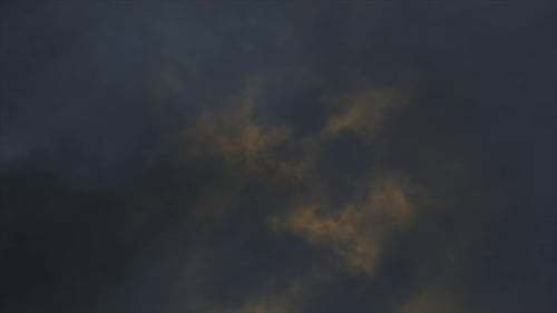 Lightning flashes through dark storm clouds