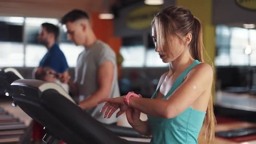 Attractive Young Woman on Treadmill in Gym Sportsman Sport Fitness Internet Face Technology Fit