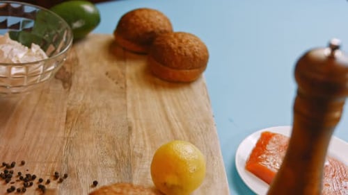 Salmon Burger Ingredients on a Blue Table