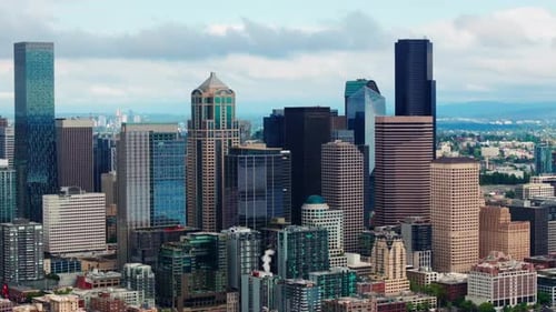 Aerial drone view of downtown Seattle, showcasing skyscrapers, urban streets, and the city skyline