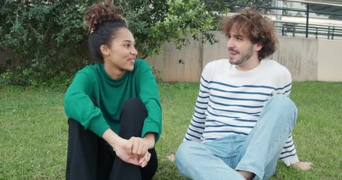 Young Heterosexual Couple of Wedding Friends or Friends Talking to Each Other in a Park