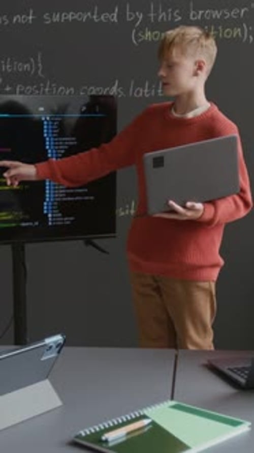 Vertical of Student Presenting Coding Project on Screen at Lesson