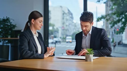 Professional Colleagues Discussing Teamwork at Corporate Conference Room Closeup