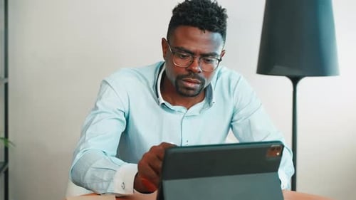 Freelancer Working with Tablet in Home