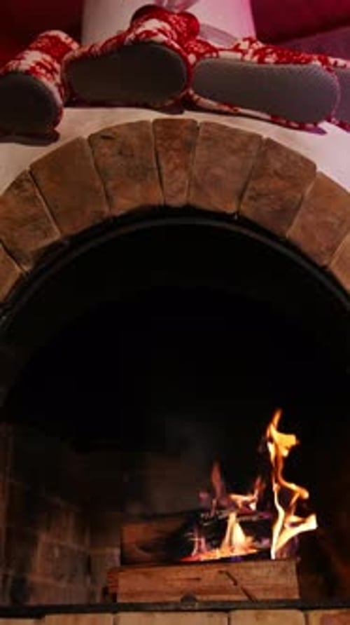 Warm fireplace at Christmas holidays. Wood burning in a beautiful brick fireplace.