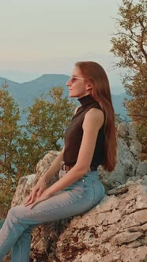 Young Woman Wearing Sunglasses Enjoying Scenic Mountain View in Turkey