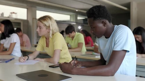 Multiracial Group of Teenager High School Students Studying in Classroom