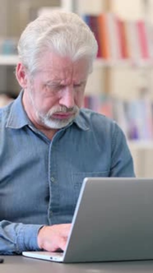 Senior Man Uses Laptop and then Coughs