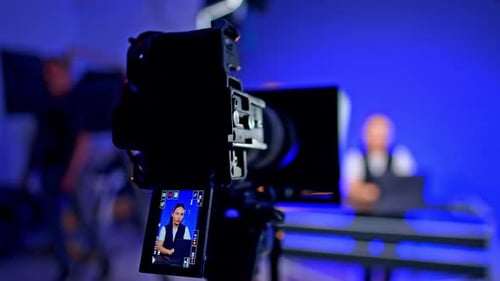 Woman Talking on Monitor Being Filmed by Camera