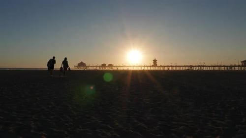 Time lapse Sunset at the pier, beautiful California beach sunset with blue sky in Huntington beach.
