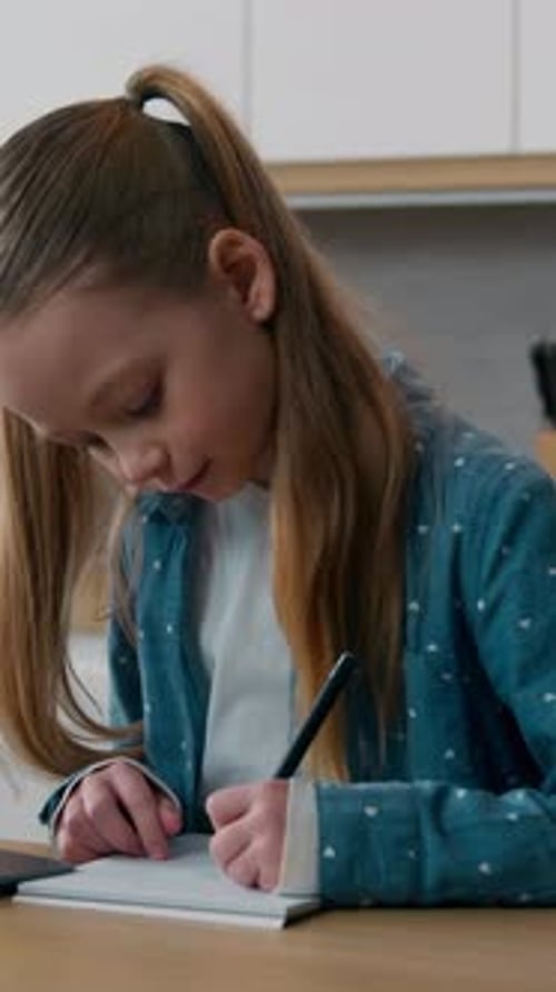Girl Writing in Notebook Indoors