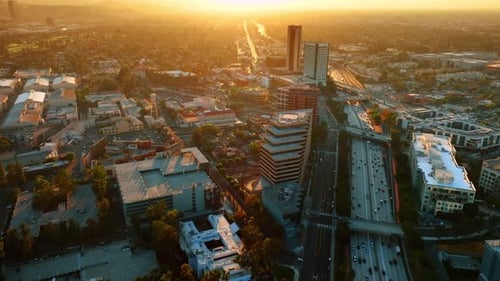 Busy road with freeways above crossing the cityscape of the city. View of LA, California, the USA