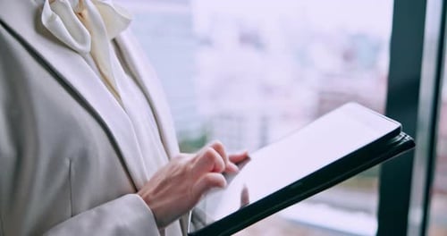 Woman, hands and tablet at window for business, update schedule and planning in office