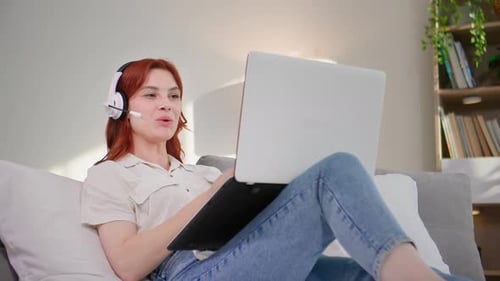 Woman Relaxing at Home Engaging in Online Meeting