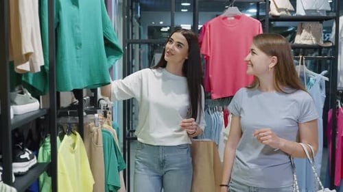 Female friends doing shopping together at fashion store