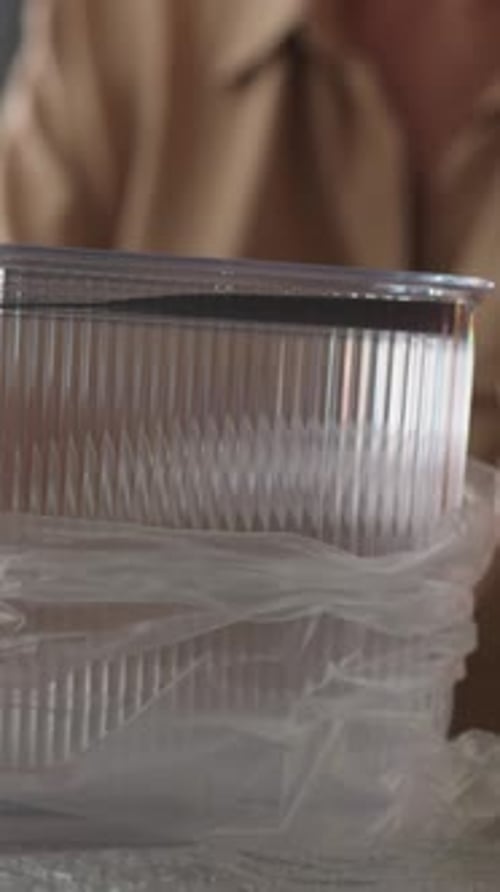 Woman Examines Container for Storing Loose Food Products