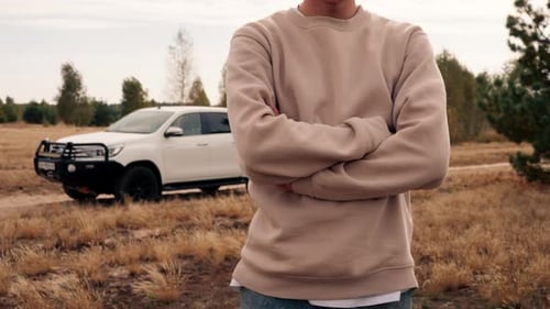 Person Standing by a Truck in a Field