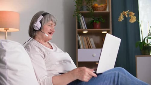 Woman Using Laptop for Video Call at Home