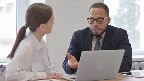 Business Discussion on Laptop in Modern Office