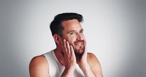 Studio, grooming and man with beard, face and smile for fresh shave, routine and facial treatment