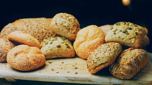 Variety of Fresh Bread and Rolls on Board
