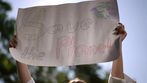 Young Adult Holding "Save the Planet" Sign