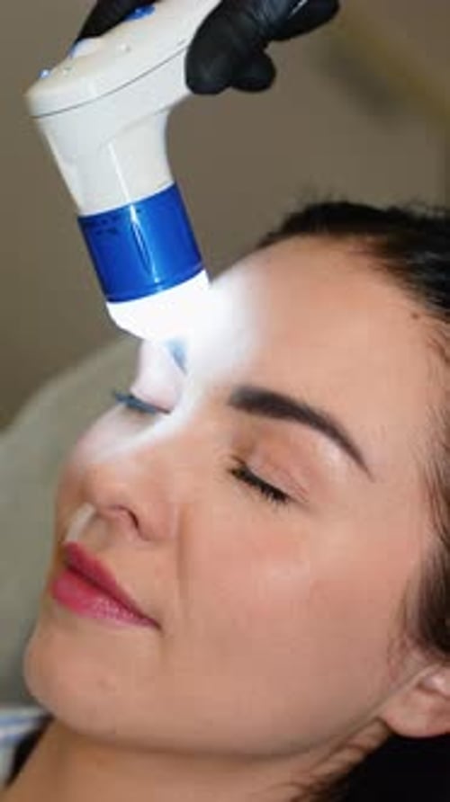 Woman Receives Bright Light Treatment on Face