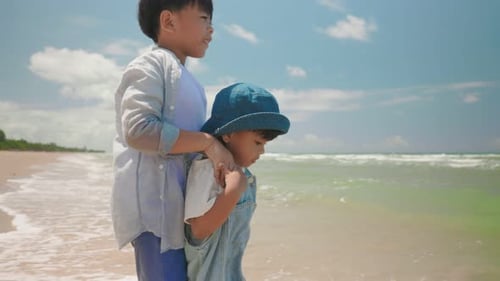 Slow motion footage happy two asian boy child play water at the beach