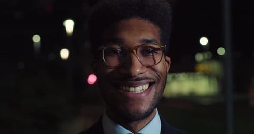 Handsome Black Man Standing in the Street at Night
