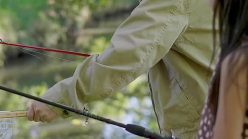 Senior Man Fishing With A Child In Nature