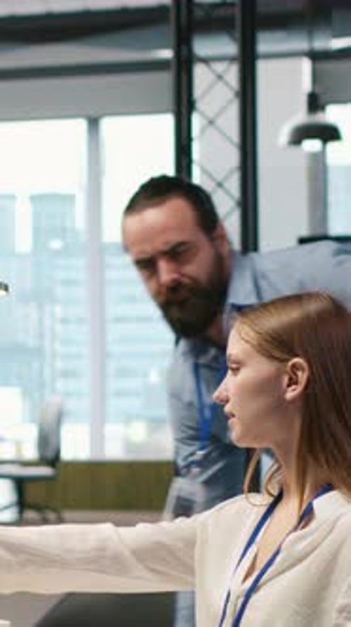 Colleagues Collaborating on Computer in Bright Modern Office