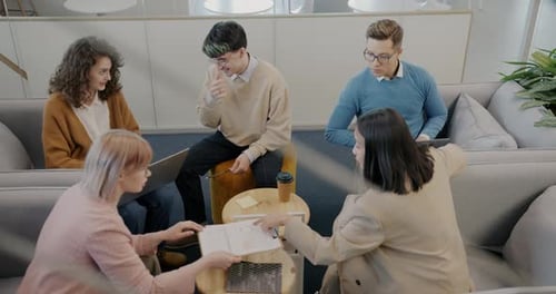 Motivated Employees Working in Comfortable Office Room Sharing Ideas