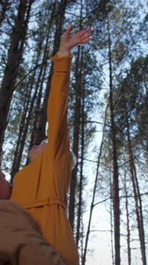 Vertical Video Old Married Couple Circling in the Forest in the Autumn Sunlight