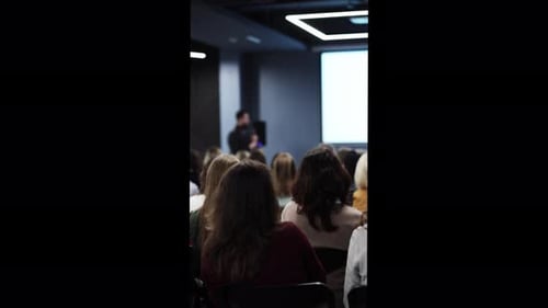 Audience Watching Corporate Presentation in Conference Room