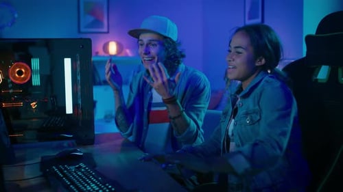 Excited Young Adults Gaming Together at Home