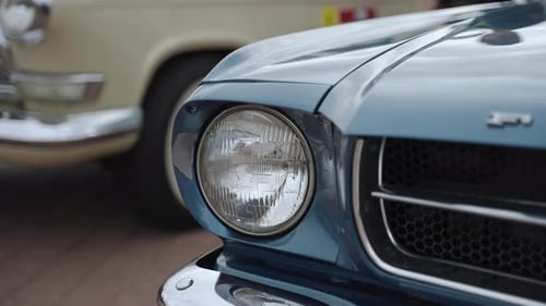 Blue Vintage Car Headlight and Grill Close Up