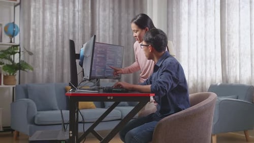 Asian Teen Boy Students Studying Software Code From His Sister
