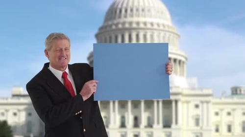 Politician Holding Sign In Front Of Us Capitol