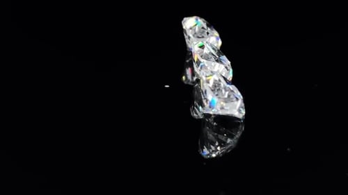 Sparkling Round Cut Diamonds on Black Reflective Surface