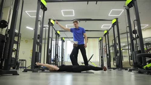 Special Personal Trainer Helps with Resistance Band Exercises in the Gym for Better Physical Fitness