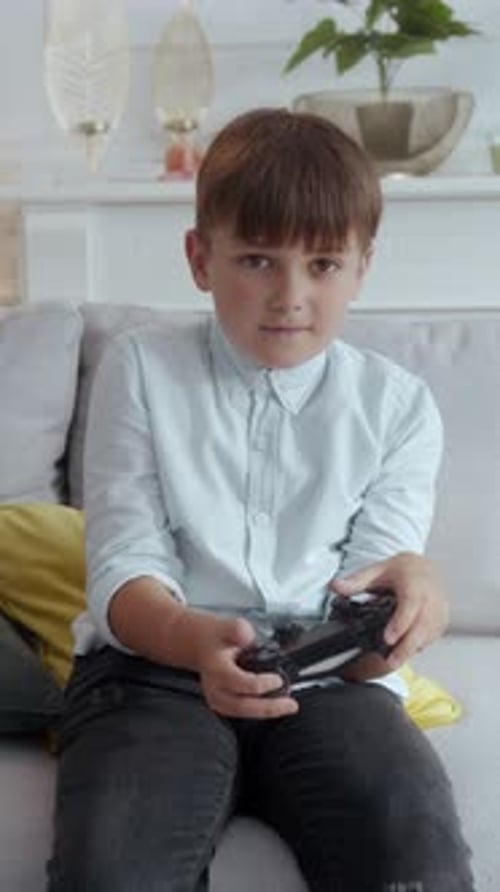 Boy Plays Video Game on Couch, Wins