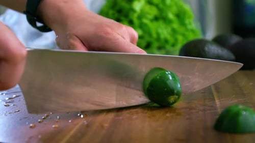 Cutting The Tip Of A Green Organic Cucumber. Selective Focus Shot