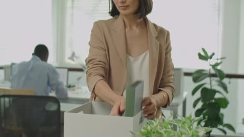 Businesswoman Packing Office Stuff After Getting Fired