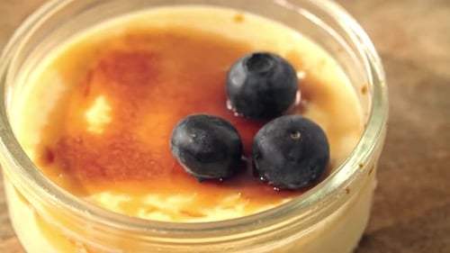 Creme Brulee with Three Blueberries in Glass Bowl