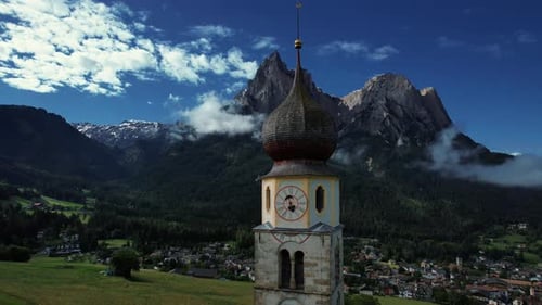 4k Drone Flys Next To Clock Tower And Spire With Mountains Of Seiser Alm In Background, Dolomites In