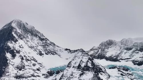 Distant view of rescue helicopter fly near Switzerland mountain with glacier